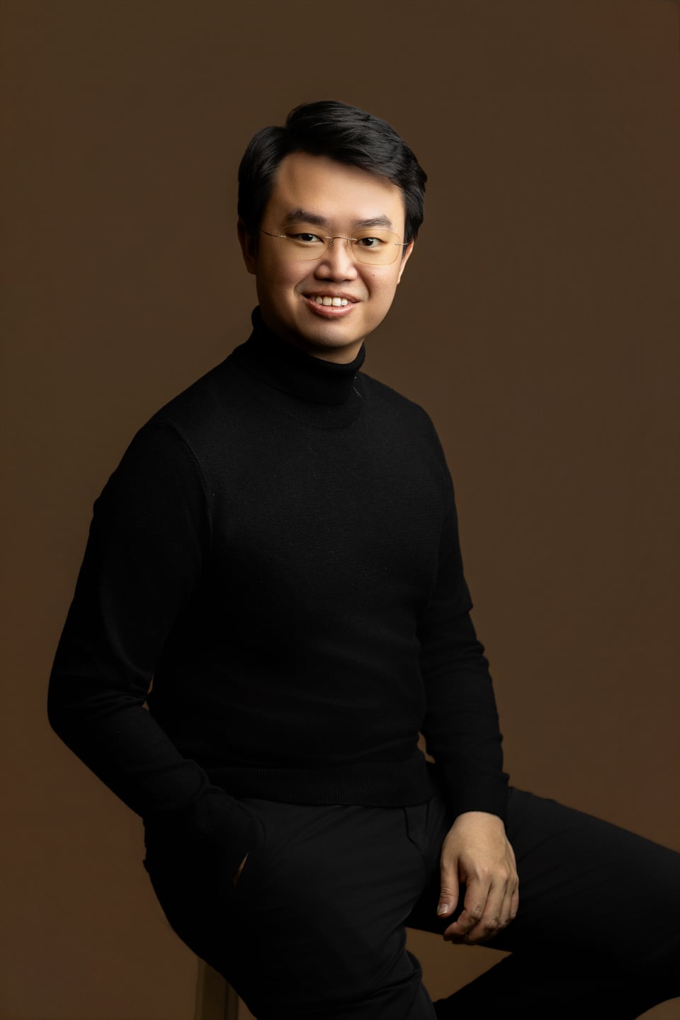Jonathan Chew, seated in a black sweater